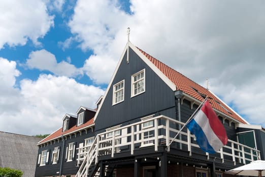 traditional wooden house with dutch flag in Marken, Netherlands