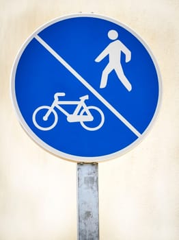 Bicycle and pedestrian lane road sign on pole post, large blue round isolated bike cycling and walking walkway footpath route traffic roadside signage
