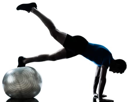 one caucasian man exercising workout fitness ball in silhouette studio  isolated on white background