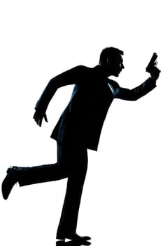 spy criminal policeman detective  man running holding gun full length silhouette in studio isolated white background