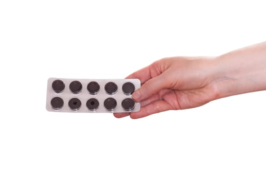 Female hand handing a blister with medication
