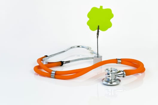 Orange stethoscope and green sticky note