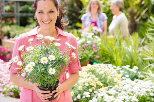 Woman shopping at flower shop green house garden centre