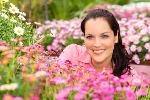 Portrait beautiful woman with purple daisy flowers in garden center