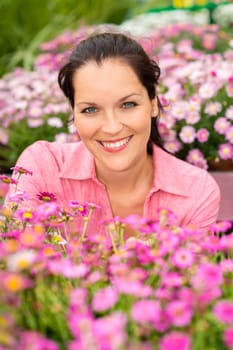 Portrait beautiful woman with purple daisy flowers in garden shop