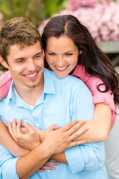 Happy affectionate couple hugging in blooming garden love romance embrace
