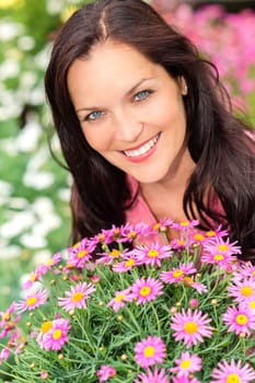 Portrait beautiful woman with purple daisy flowers in the garden