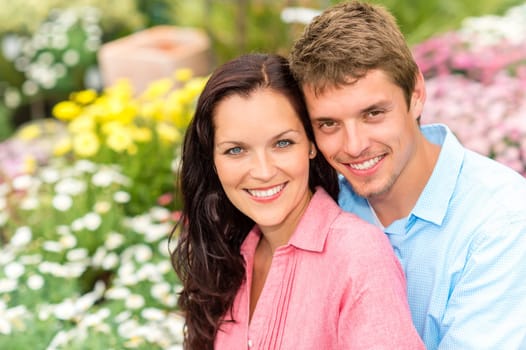 Happy young couple in love hugging in nature garden