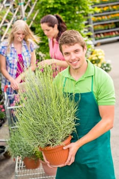 Male garden centre worker hold potted plant
