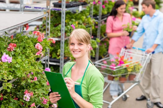 Female florist working at garden centre retail inventory
