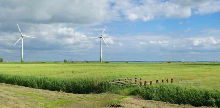 two windmills in a rural landscape in the Netherlands