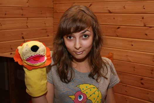 Girl smiles with soft toy on hand