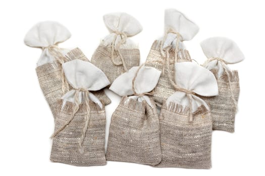 Sac pervaded spice and tied rope on white background