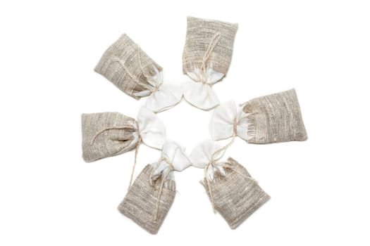 Sac pervaded spice and tied rope on white background