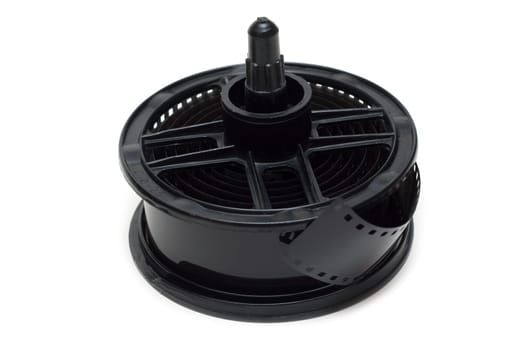 Spool for proappearance with negative monochrome film on white background