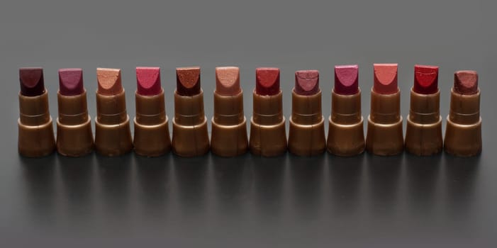Small tubeses lipstick on dark gray background