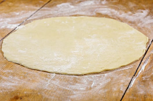 raw pizza base without toppings