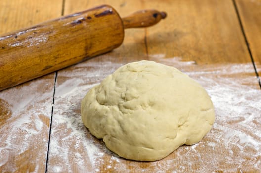 Yeast dough with rolling pin