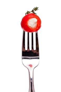 Red hot pepper with cheese filling on a fork