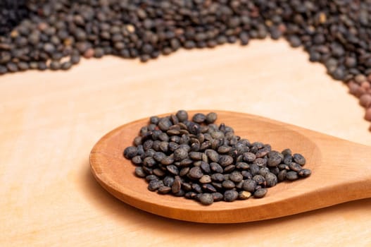 Wooden spoon with black beluga lentils