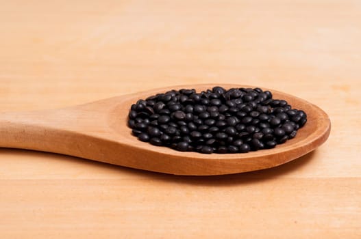 Close-up black lenses on a wooden spoon