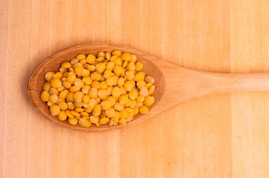 Close-up yellow lentils in a spoon