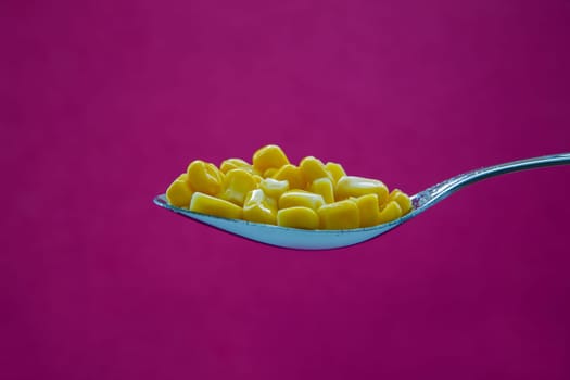 Yellow corn is ready for eating on spoon