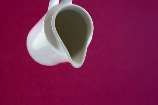 White pot for some liquid on pink background