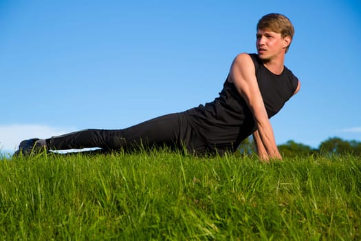Sportsman is stretching its stomach and back muscles