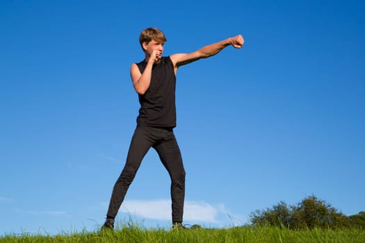 Sportsman is making fighting movements with left hand