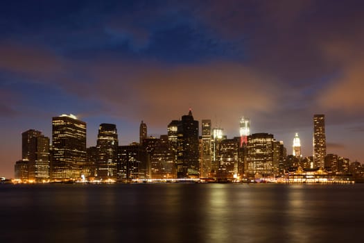 Manhattan skyline by night from Brooklyn bridge park - USA