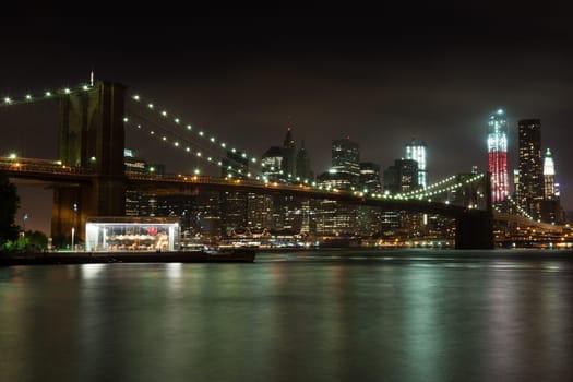 Manhattan skyline by night from Brooklyn bridge park - USA