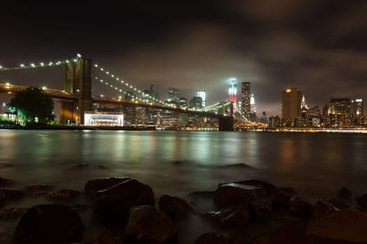 Manhattan skyline by night from Brooklyn bridge park - USA