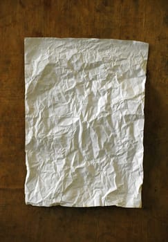 old crumpled paper on wooden wall