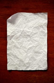 old crumpled paper on wooden wall