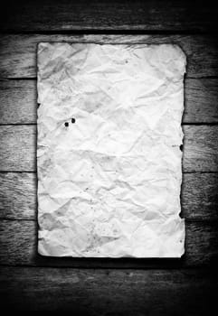 old crumpled paper on wooden wall