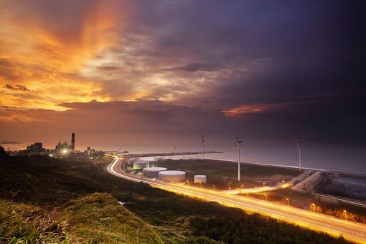 A road and windmills during sunset, made with a wide angle lens