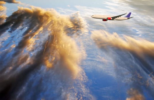 large airliner flying into dramatic cloudscape, sunset, ocean visable through clouds