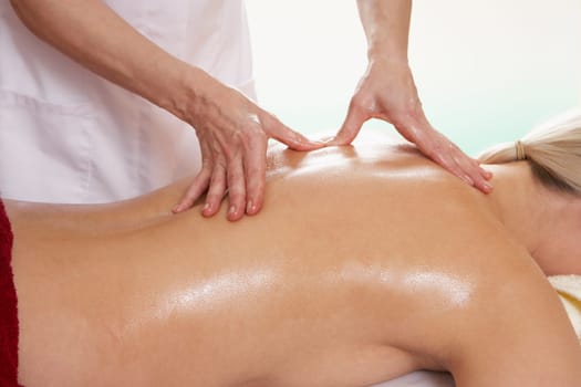 Woman with tattoo having back massage