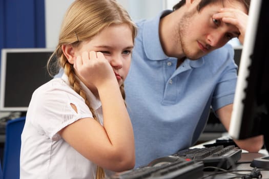 Unhappy teacher and girl using computer in class