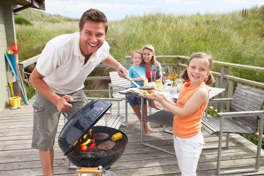 Family on vacation having barbecue