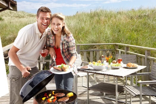 Couple on vacation having barbecue