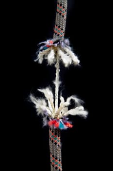 A rope is breaking on a black background