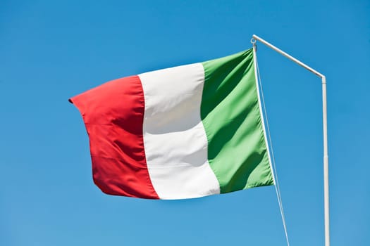 Flag of Italy towards blue sky
