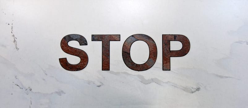 Inscription stop in aeroport on light marble
