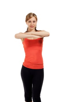 Young sportswoman exercising in front of white background
