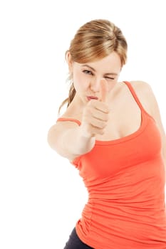 Young sportswoman aiming with thumb against white background