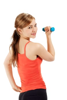 Cute sportswoman with fitness dumbbell looking over shoulder against white background