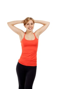 Young sportswoman with arms behind her head against white background