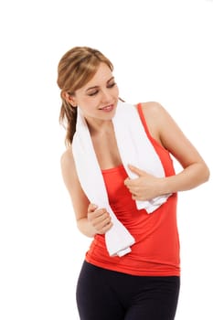 Young sportswoman with towel looking to the side against white background